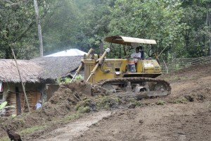 A bulldozer operator removes the unsuitable materials before the road improvement with spot concreting and cross drains project starts in Brgy. Napnot , Madalag.