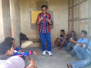 Eduardo Guevarra, Focal Person on Women, Family and Community explains the difference between “sex” and “gender” to the fathers in the bunkhouses in Barangay Gogo, Estancia, Iloilo.