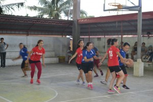 Wearing its blue uniform, RPMO Basketball Team player dribbles against Iloilo POO Basketball Team player in red uniform during the exhibition game at the Molo Terminal Gym, Iloilo City